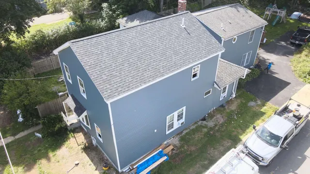 Aerial view of the house with siding installation and roof raised in worcester ma