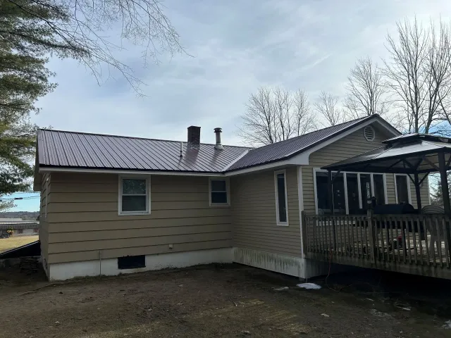 Rear View of Home With Metal Roofing Surface