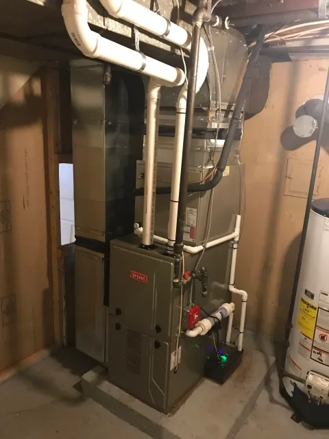House basement with a large HVAC system including furnace and water heater.