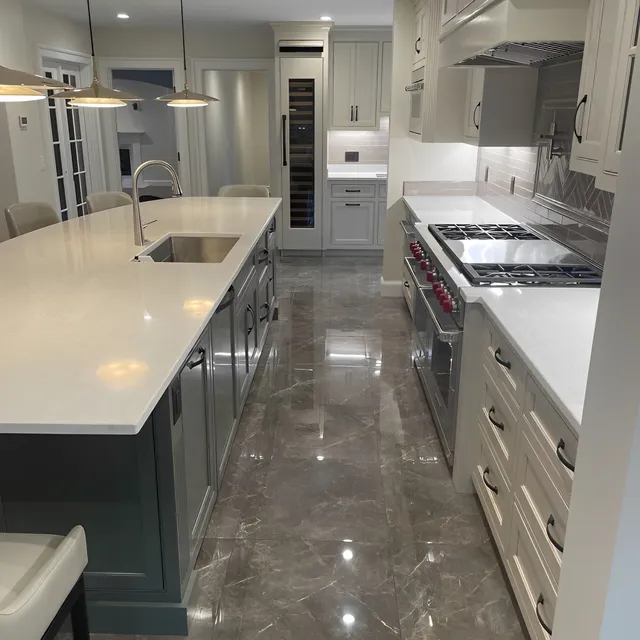 A Spacious Kitchen Featuring A Large Island With A Sink, Designed For Functionality And Modern Aesthetics.