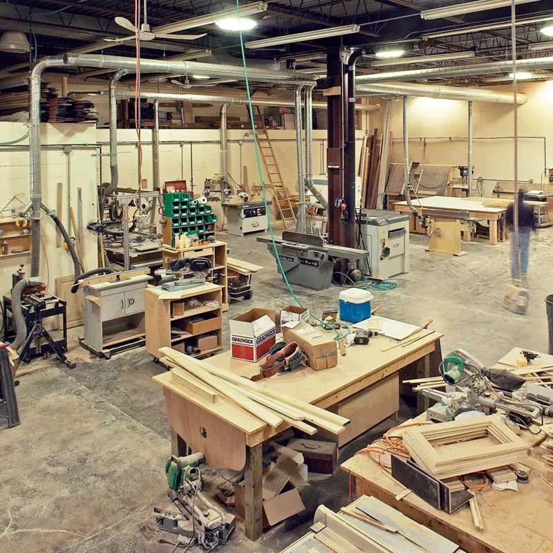 A large room with many wooden work benches.