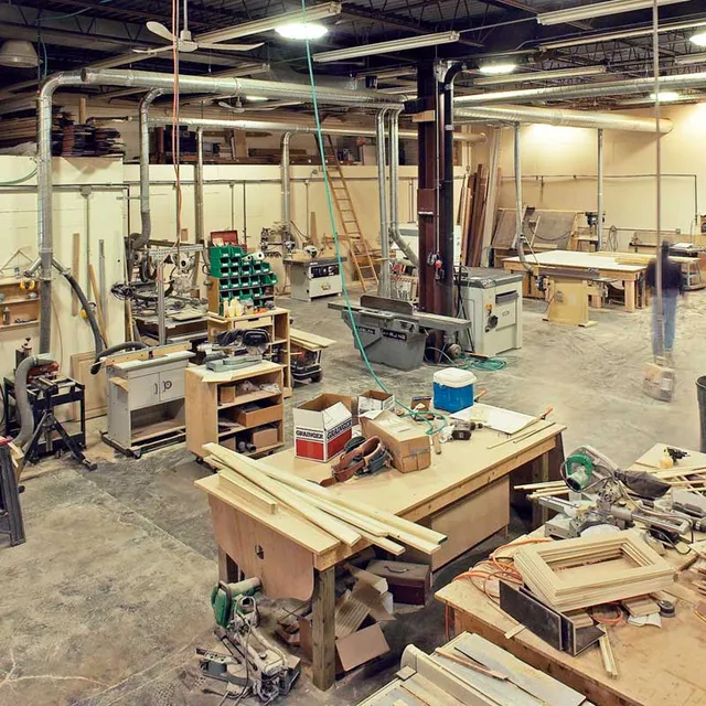 A large room with many wooden work benches.
