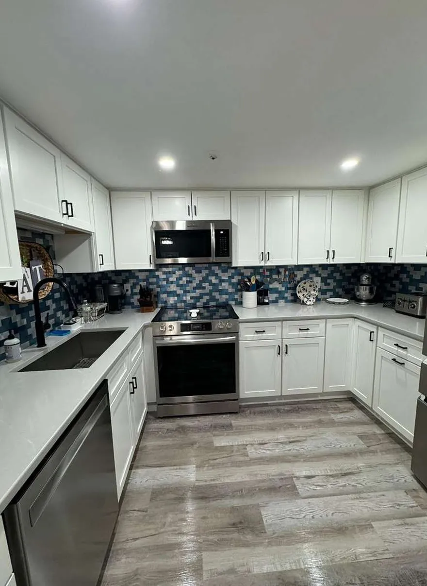 Spotless white kitchen with pristine counters cleaned by Allegry Cleaning Services