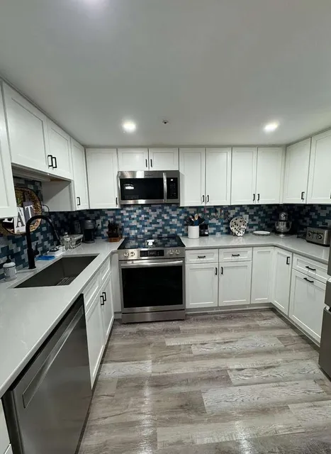 Spotless white kitchen with pristine counters cleaned by Allegry Cleaning Services