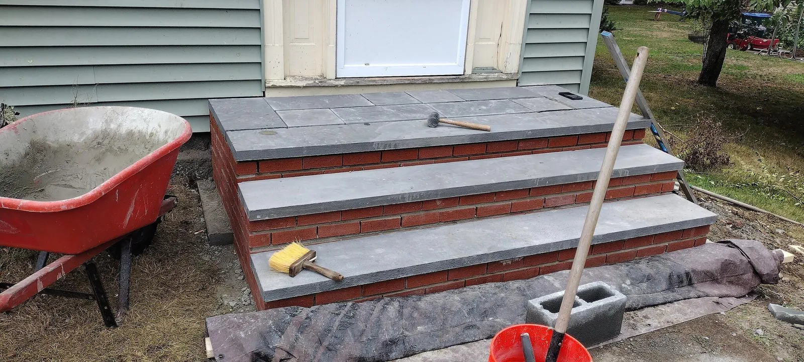 Brick and bluestone entry steps under construction
