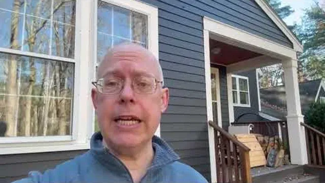 Person standing outside a finished house in a Target Painting video