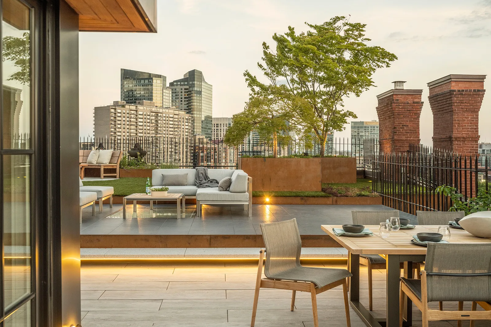 Urban roof terrace with raised corten planters and multi-stem trees