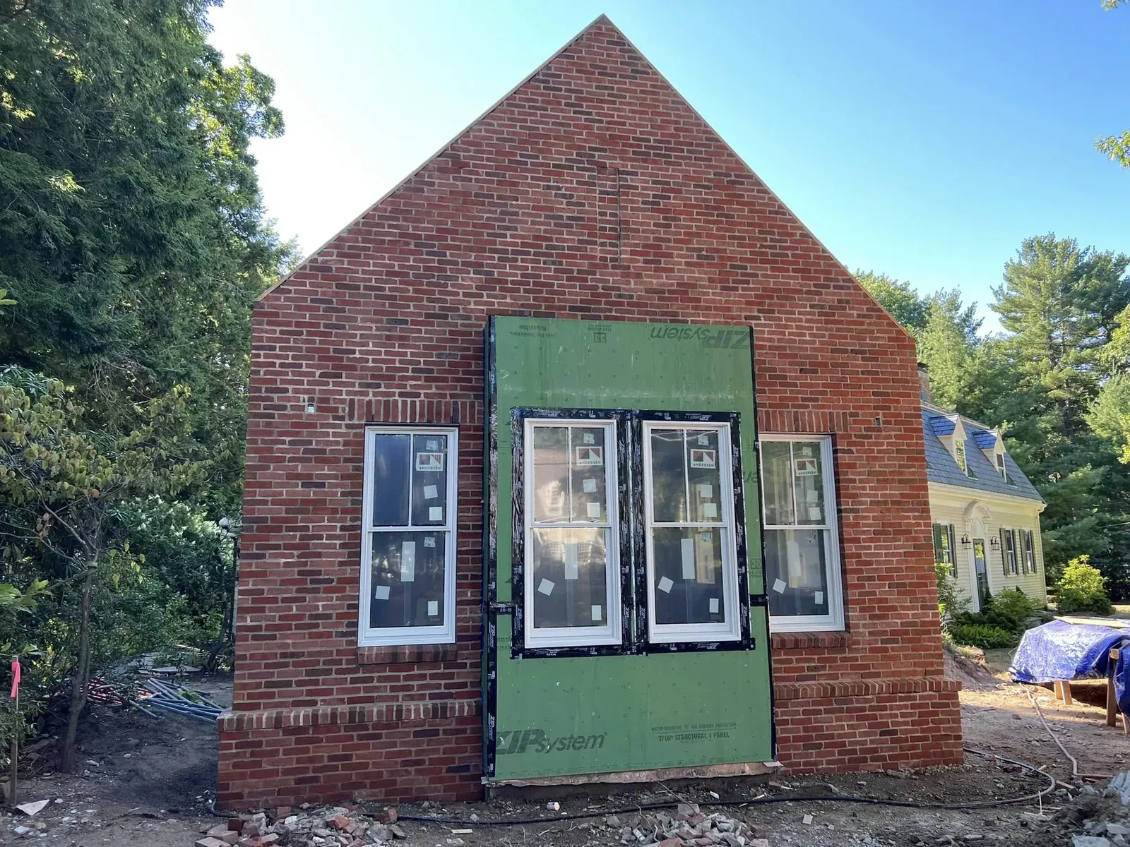 Red brick façade under construction with clean masonry coursing