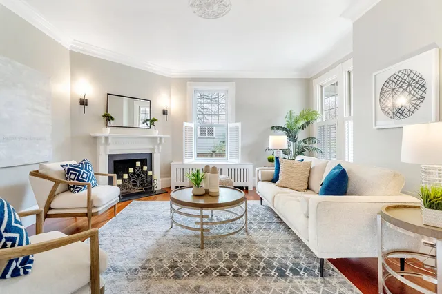 Living room with restored mantel, sconces and crown moulding