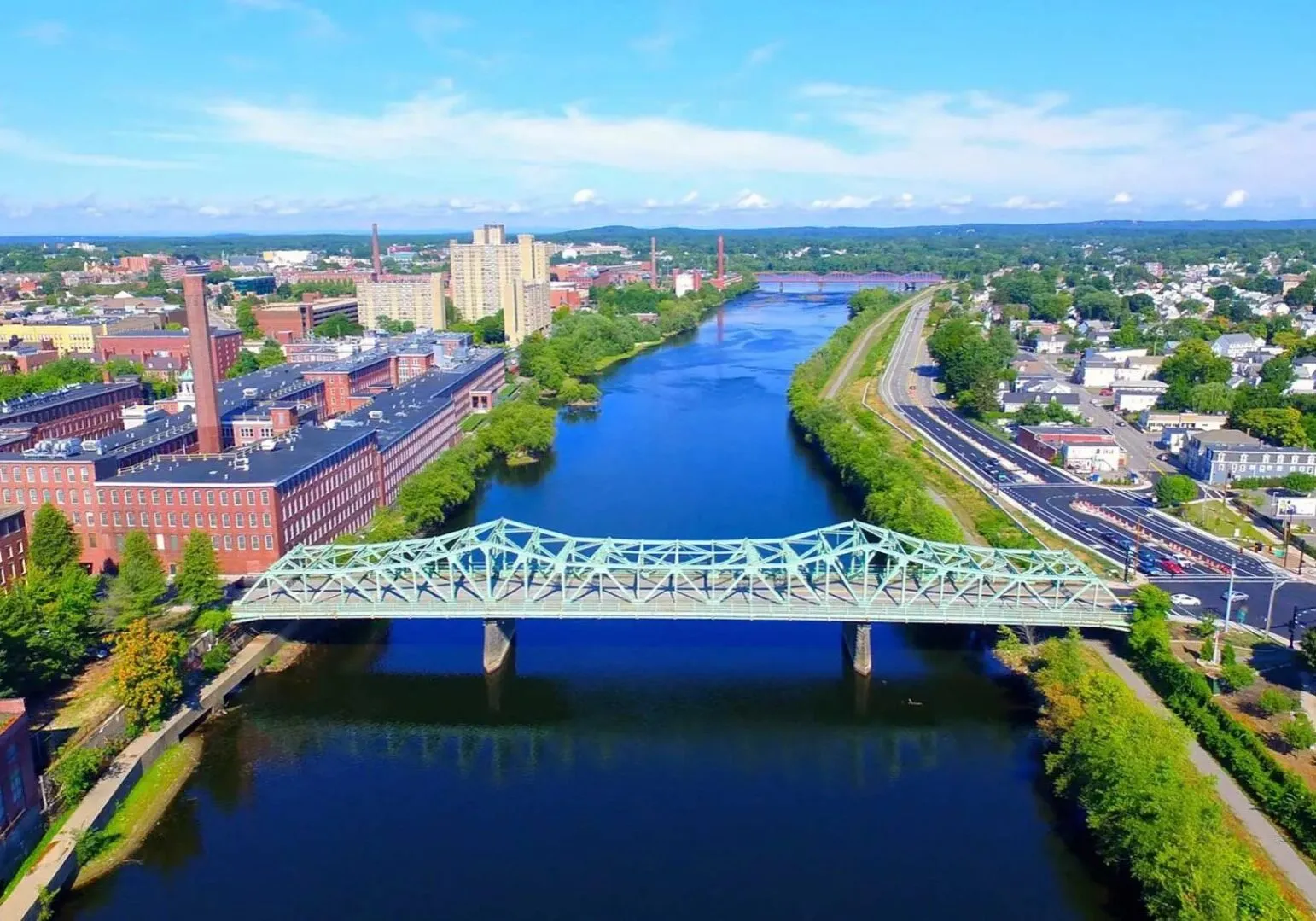 Aerial view of Lowell, MA, and a bridge.