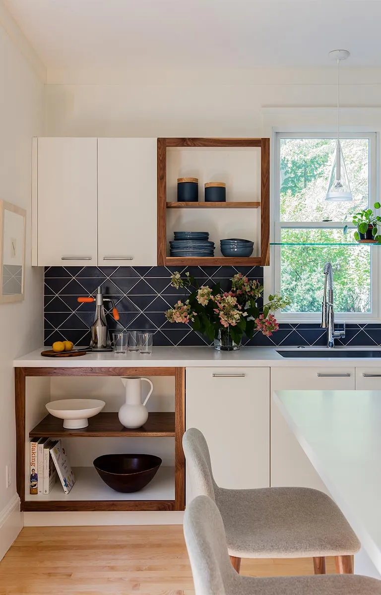 A kitchen with white cabinets and a counter top