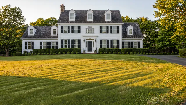 Front lawn restored to dense green grass after aeration and overseeding