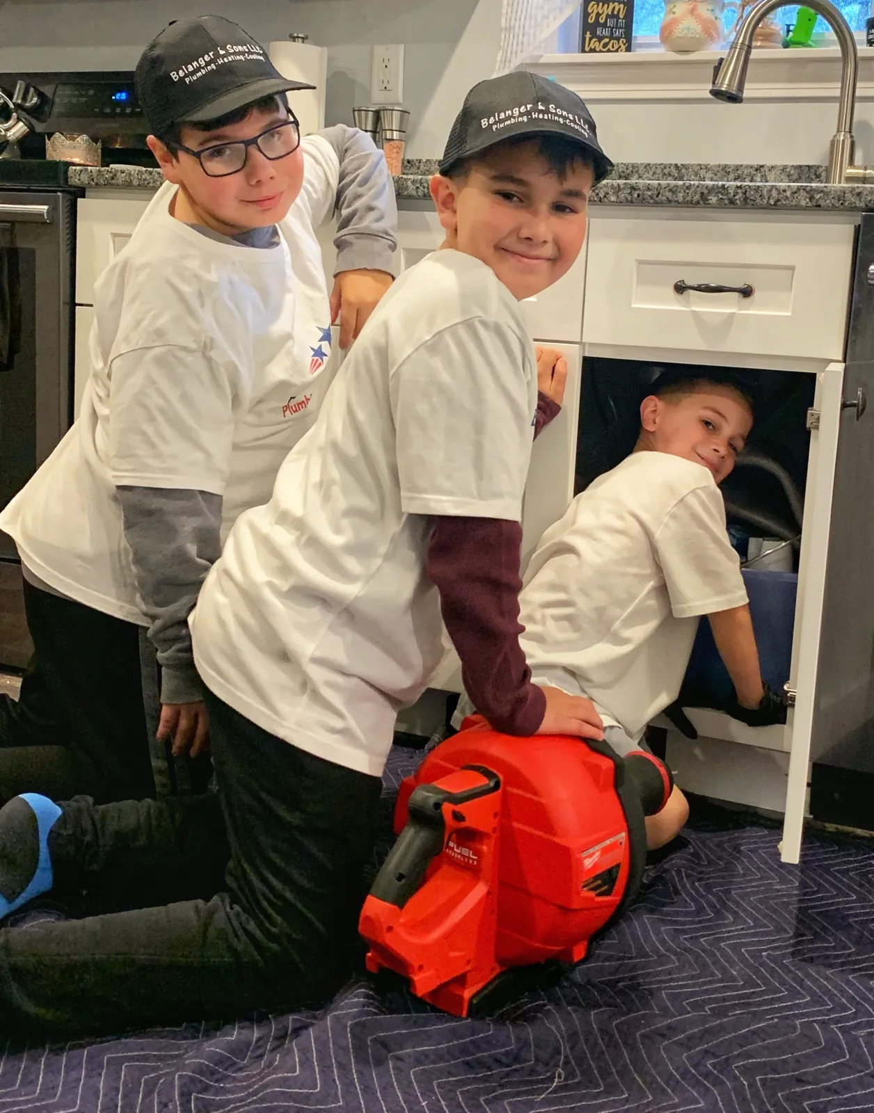 Kids fixing a sink at Belanger and Sons Plumbing and Heating.