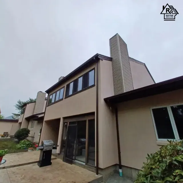 A large house with a chimney on the top of it