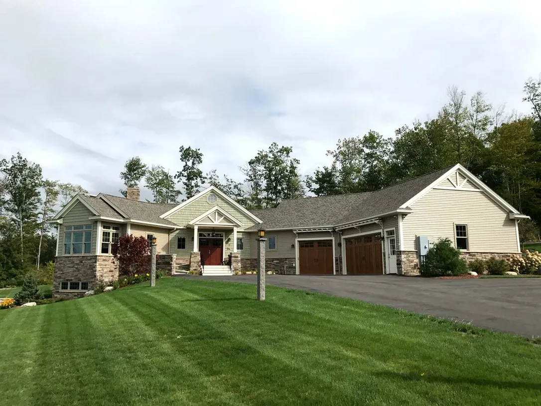 Large yellow house with mowed lawn