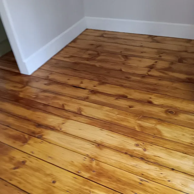 A room with wood floors and white walls.