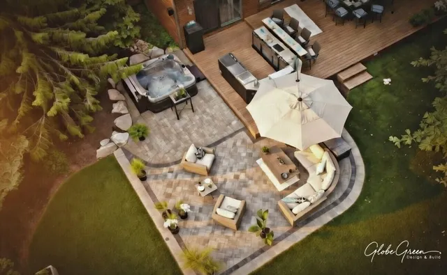 Aerial view of a backyard paver patio with pergola and outdoor living areas near Concord, NH