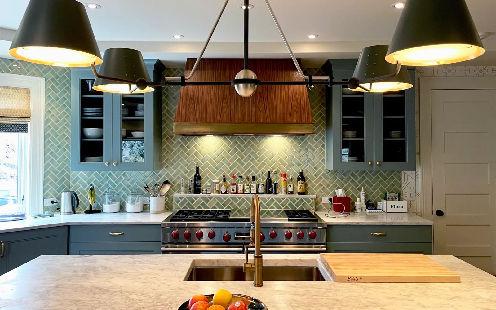 Custom kitchen with tiled backsplash and range hood