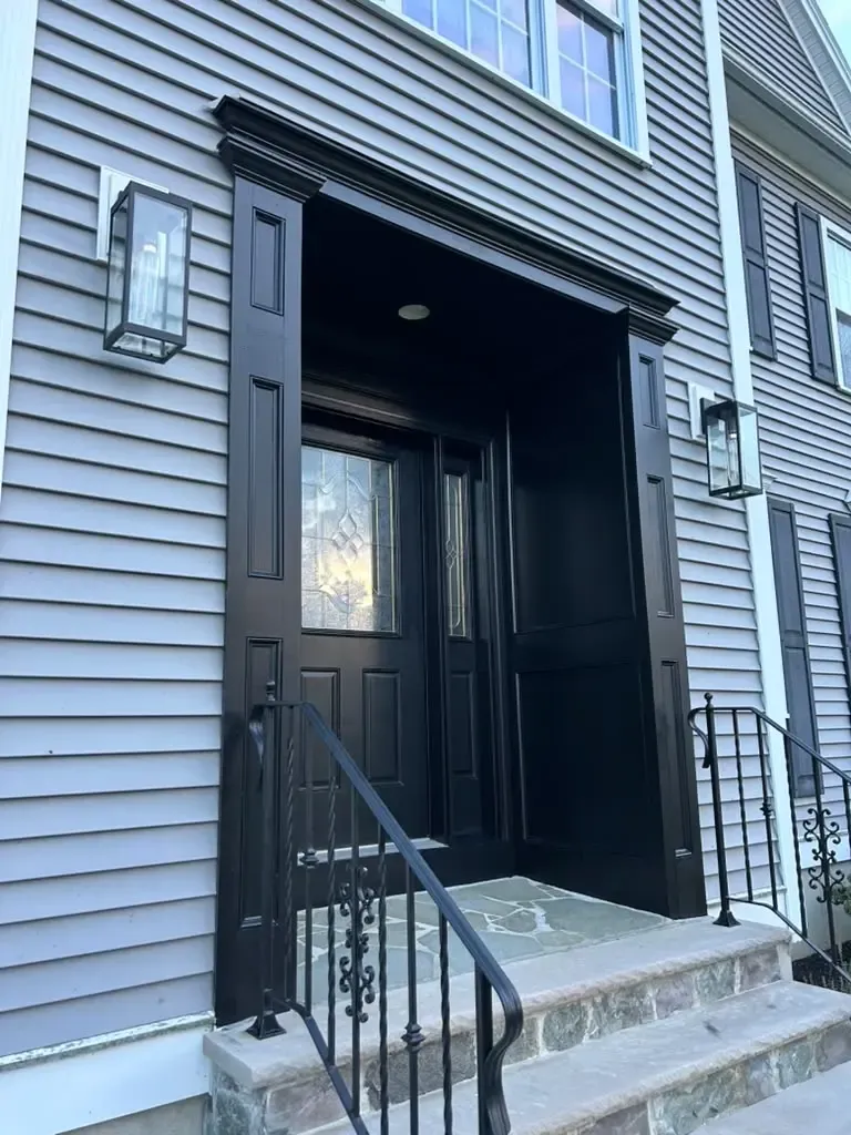 Freshly repainted black front entry viewed from the side