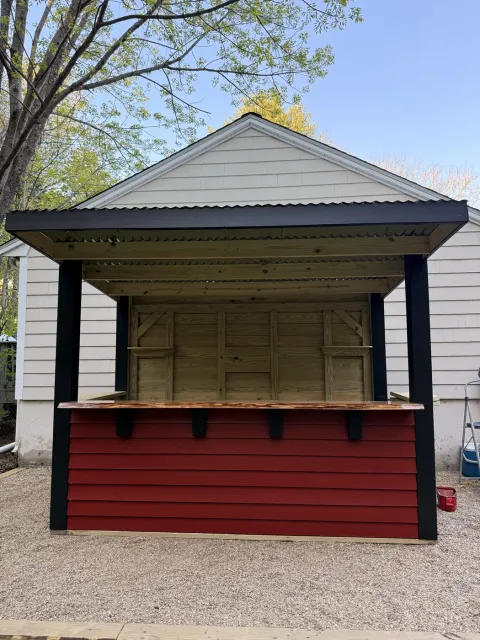 Finished custom outdoor bar in Pembroke with red panels and black trim