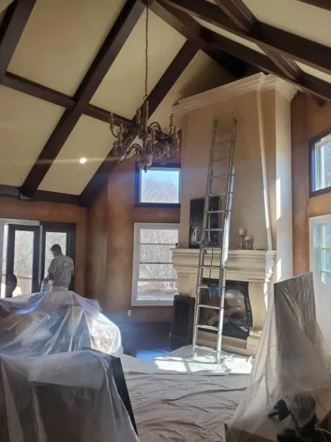 A living room with a ladder in the middle of it