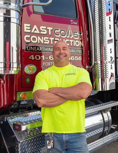 East Coast Construction worker smiling in front of his truck