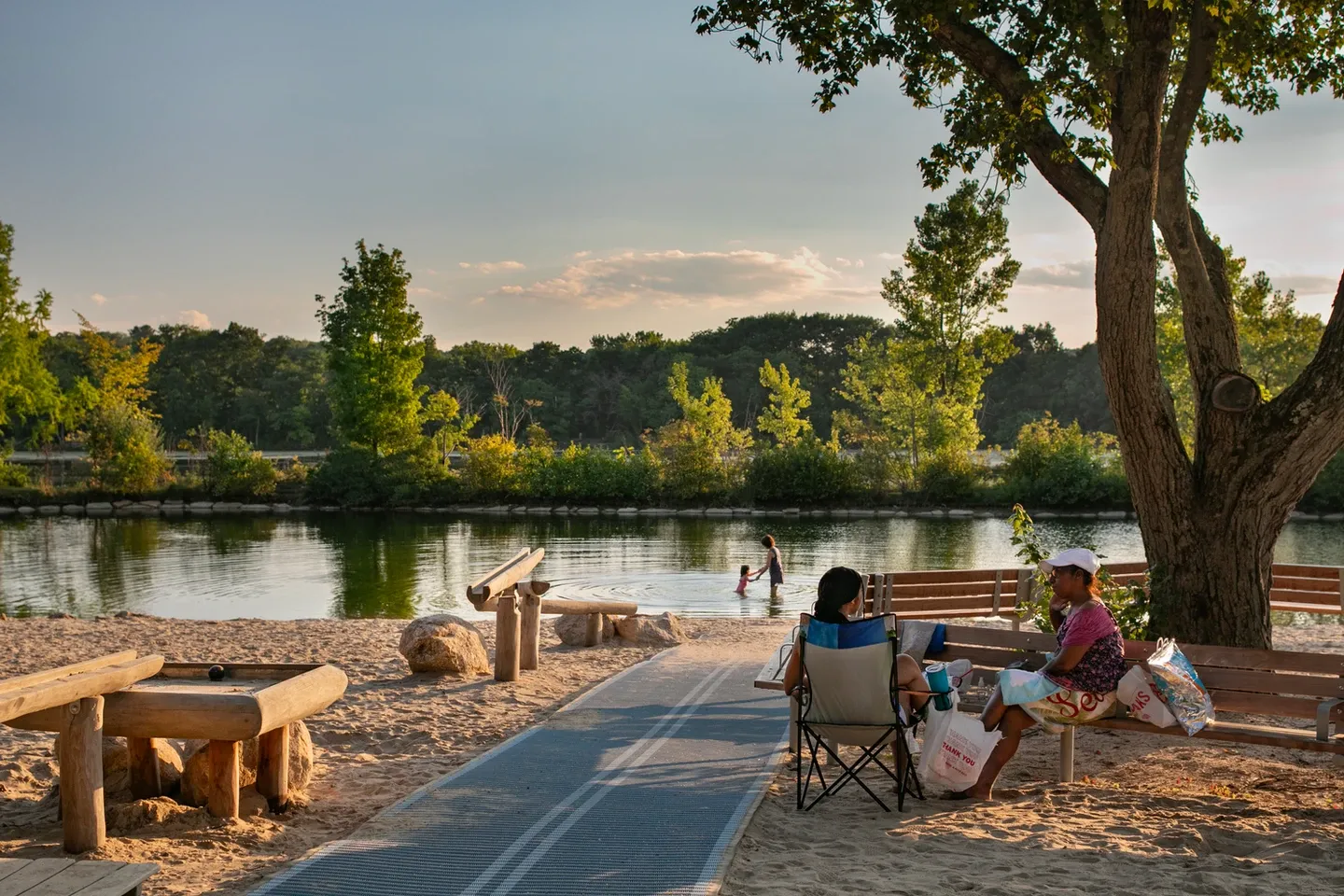 Serene view of a family sitting near a pond