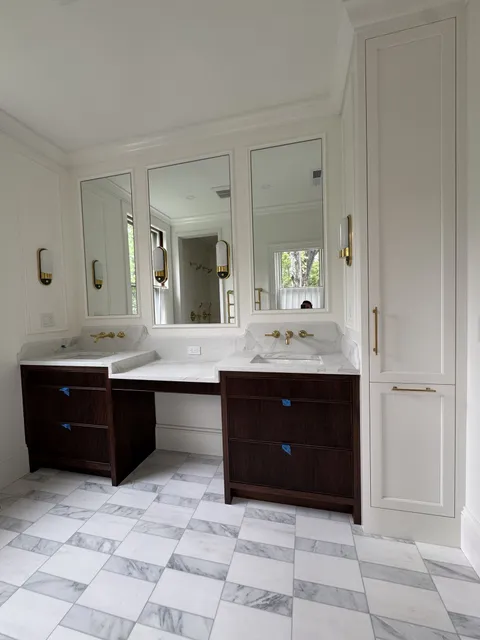 Custom walnut double bathroom vanity with makeup station and marble top