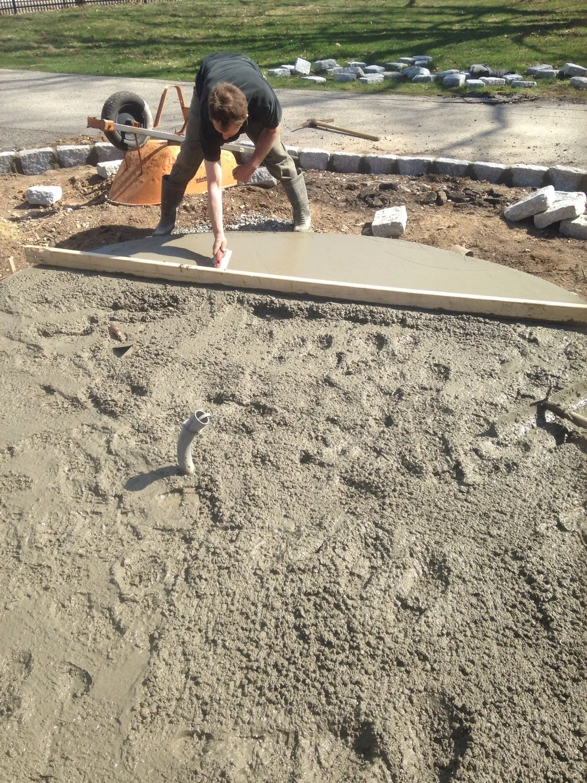 Finishing a poured concrete walkway slab with granite cobble border