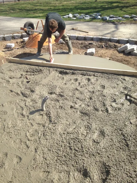 Finishing a poured concrete walkway slab with granite cobble border