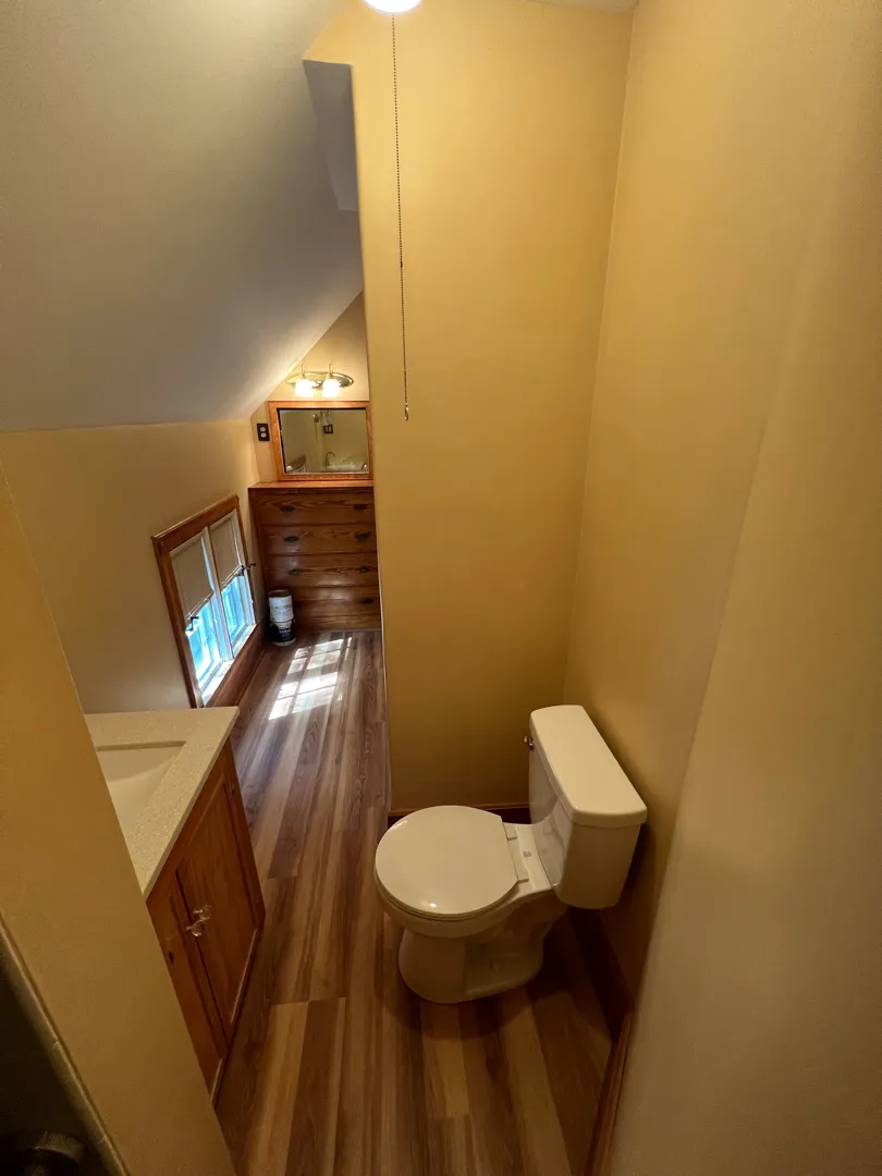 Small bathroom after fresh walls, flooring, and fixtures