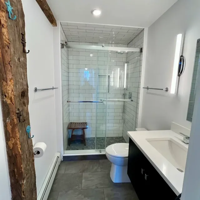 Bathroom remodel with glass shower and exposed beam — North Shore, MA — Albion Contracting