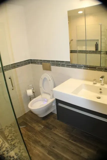 Remodeled bathroom with wall-hung fixtures