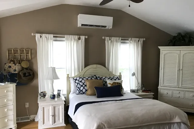 A Mitsubishi ductless mini split installed by Robies in a Cape Cod bedroom, providing efficient and quiet heating and cooling comfort without the need for ductwork