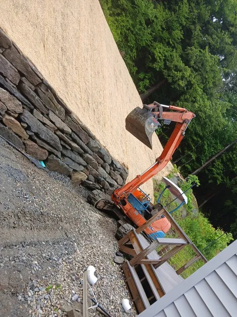 Excavator on the wall line