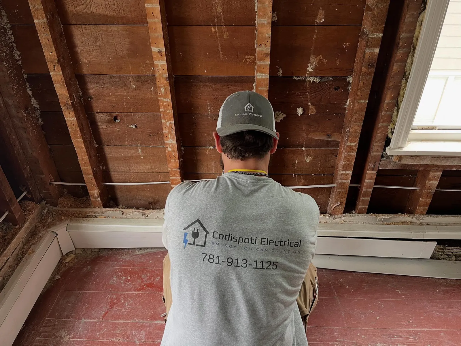 Codispoti Electrical technician working on an open ceiling