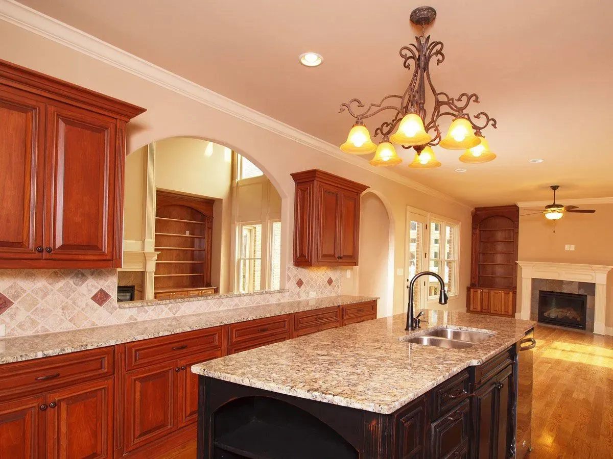 A kitchen with granite counter tops and wooden cabinets