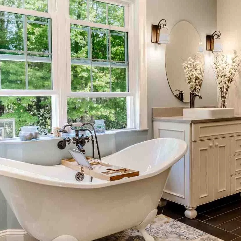 A stylish bathroom with a classic claw foot tub positioned near a window, enhancing the room's ambiance.