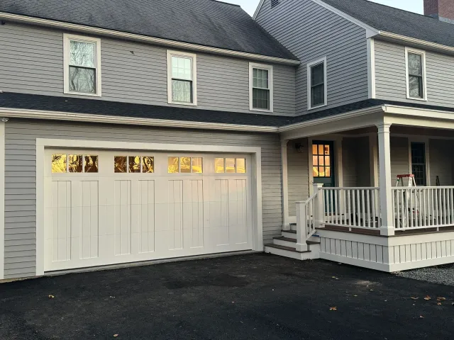 A house with a white garage door and a porch