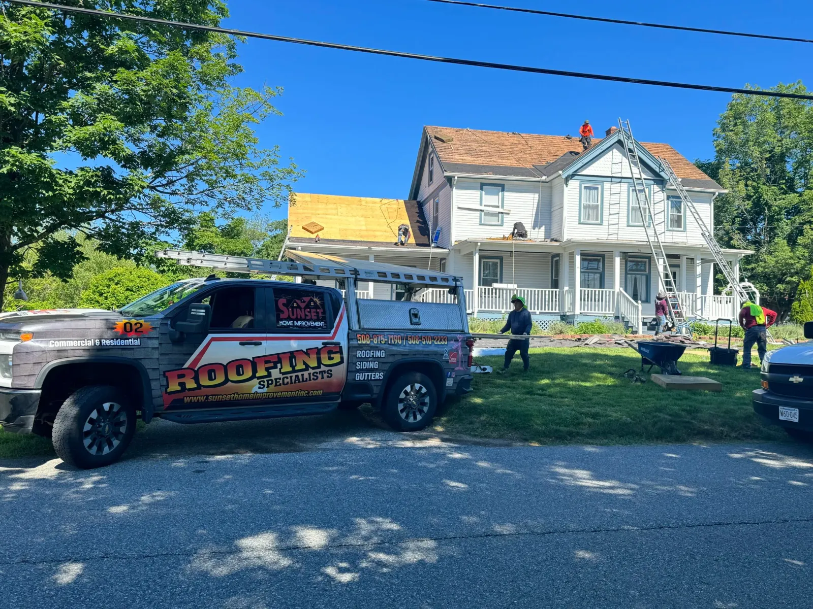Sunset Home Improvement crew and truck at a roofing installation in Easton MA