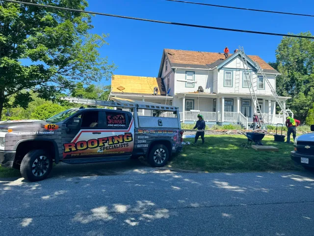 Sunset Home Improvement crew and truck at a roofing installation in Easton MA