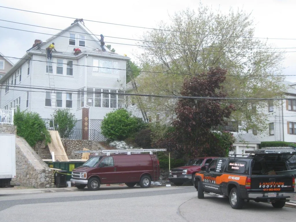 Technician performing roofing work in a confined space with precision and care.