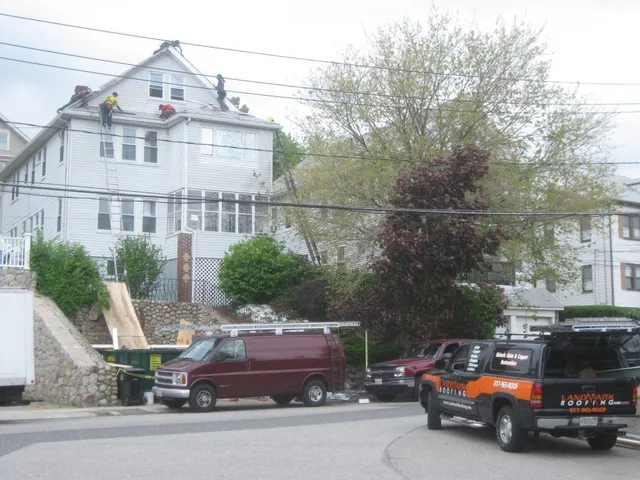 Technician performing roofing work in a confined space with precision and care.