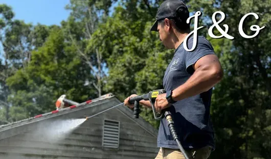 J&G Power washing siding on a residential house