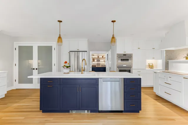 Two-tone Milton kitchen with a navy island and white perimeter cabinetry by Transitions