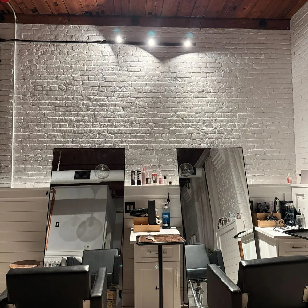 Boston Light & Power electrician installing track lighting in a salon in Quincy, MA.