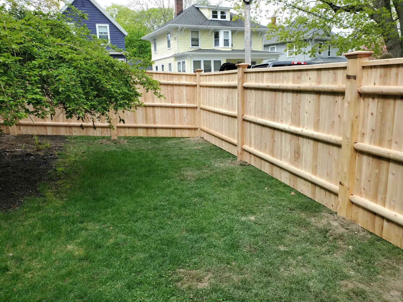 Cedar wood fencing installed by Olympic Fence Company, enhancing curb appeal in a North Shore Massachusetts neighborhood.