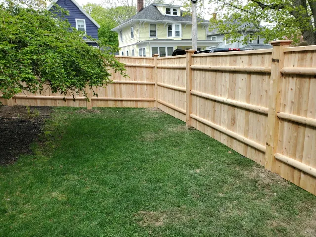 Cedar wood fencing installed by Olympic Fence Company, enhancing curb appeal in a North Shore Massachusetts neighborhood.