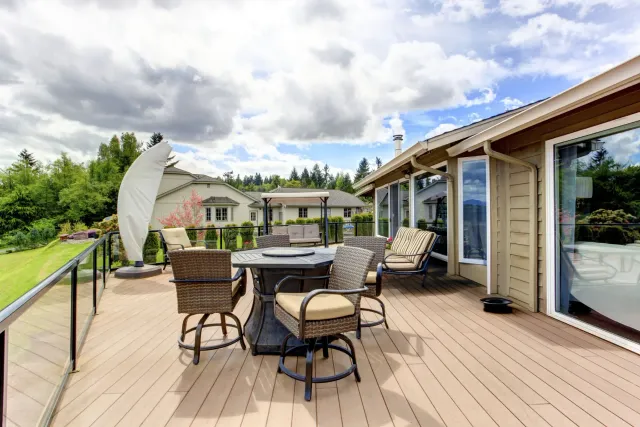 walkout-commercial-deck-with-patio-area-and-glass-railing-on-the-mocha-house-with-multiple-windows-with-overlooking-view-in-oxford-connecticut.webp