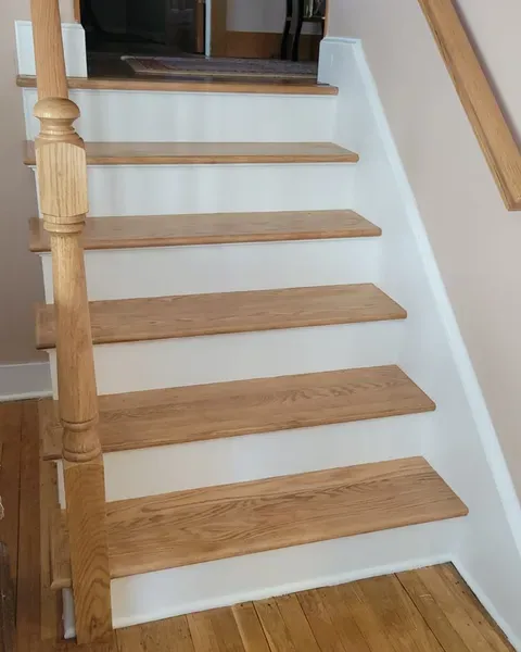 Oak stairway refurbishment by Pro Handyman Services — custom treads, risers, and newel post